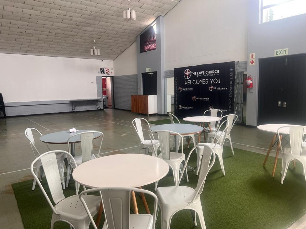The hall at The Love Church set with round tables
